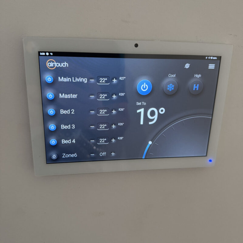 Wall-mounted zone controller showing temperatures for each room